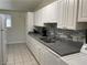Spacious kitchen featuring white cabinetry, stainless steel sink, and modern tile backsplash at 1812 Ryan Ave, Las Vegas, NV 89101