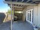 Covered patio with brick floor, storage area and door to backyard at 1812 Ryan Ave, Las Vegas, NV 89101