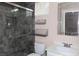 Bathroom featuring tiled shower with glass door, single vanity, and decorative accents at 427 Norridgewock St, Henderson, NV 89074