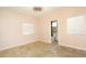 Spacious bedroom with neutral paint, ceiling fan, and view into en suite bathroom at 427 Norridgewock St, Henderson, NV 89074