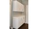 Hallway with built in white cabinets and drawers for extra storage at 427 Norridgewock St, Henderson, NV 89074