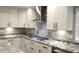 Modern kitchen features granite counters, stainless steel appliances, and sleek white cabinets with stylish hardware at 427 Norridgewock St, Henderson, NV 89074