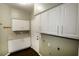 Well-lit laundry room offers practical white cabinetry and countertop for added convenience at 427 Norridgewock St, Henderson, NV 89074