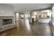 Spacious open-plan with stone fireplace, flowing into a chef's kitchen with white cabinets and modern appliances at 427 Norridgewock St, Henderson, NV 89074