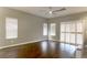Bright living room featuring sleek ceiling fan, wood flooring, and bright shutters for privacy and light at 427 Norridgewock St, Henderson, NV 89074