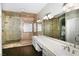 Well-lit main bathroom with a walk-in glass shower, double sinks, and tile backsplash at 427 Norridgewock St, Henderson, NV 89074