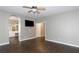 Spacious main bedroom with a ceiling fan, a mounted TV, and doorway to an adjacent room at 427 Norridgewock St, Henderson, NV 89074