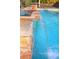 Water fountain feature flowing into a pristine backyard swimming pool with clear blue water at 427 Norridgewock St, Henderson, NV 89074