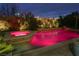 Backyard pool and spa with decorative lighting and waterfall feature, perfect for night time relaxation at 427 Norridgewock St, Henderson, NV 89074