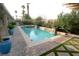 Backyard pool featuring spa, waterfall features, landscaping, and outdoor seating at 427 Norridgewock St, Henderson, NV 89074