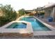 Backyard pool and spa featuring beautiful stone accents and lush landscaping at 427 Norridgewock St, Henderson, NV 89074
