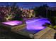 Backyard pool and spa with decorative lighting and waterfall feature, perfect for night time relaxation at 427 Norridgewock St, Henderson, NV 89074