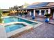 Backyard pool and spa with brick patio, covered patio, and solar panels, perfect for outdoor relaxation and entertaining at 427 Norridgewock St, Henderson, NV 89074