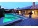 Beautiful backyard pool and spa with covered patio, solar panels, and brick patio, perfect for outdoor relaxation at 427 Norridgewock St, Henderson, NV 89074