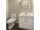 Cozy powder room featuring a toilet, sink, and vanity with cabinet storage at 427 Norridgewock St, Henderson, NV 89074