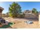 Large backyard with a mostly dirt yard and a small above ground pool at 4245 Seville St, Las Vegas, NV 89121
