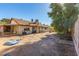 View of the home's back and side yard with dirt and a small above ground pool at 4245 Seville St, Las Vegas, NV 89121