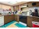 Kitchen with wood cabinets, gas range and built in microwave at 4245 Seville St, Las Vegas, NV 89121