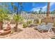 Landscaped backyard with patio furniture and a fountain at 1590 Sabatini Dr, Henderson, NV 89052