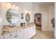 Elegant bathroom boasts double sinks, granite counters, and large mirrors at 1590 Sabatini Dr, Henderson, NV 89052