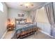 Bedroom with a metal bed frame, neutral colored bedding, and decorative pillows at 1590 Sabatini Dr, Henderson, NV 89052