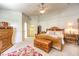 Spacious bedroom with wood furniture and a floral rug at 1590 Sabatini Dr, Henderson, NV 89052