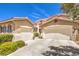 Spacious home exterior features a three-car garage, tile roof, and desert landscaping at 1590 Sabatini Dr, Henderson, NV 89052