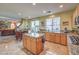 Open kitchen with granite island and view into Gathering room at 1590 Sabatini Dr, Henderson, NV 89052