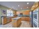 Kitchen with granite island, stainless steel appliances, and wood cabinets at 1590 Sabatini Dr, Henderson, NV 89052