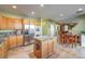 Spacious kitchen with island, stainless steel appliances, and light wood cabinets at 1590 Sabatini Dr, Henderson, NV 89052