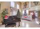 Elegant living room with high ceilings, a grand piano, and plenty of natural light at 1590 Sabatini Dr, Henderson, NV 89052