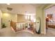 Upstairs hallway with a curved wooden railing and a full-length mirror at 1590 Sabatini Dr, Henderson, NV 89052