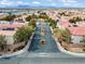 A landscaped median divides a street in this planned community at 3023 Sunset Harbor Ct, North Las Vegas, NV 89031