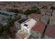 Aerial view of a compact home with a red tile roof, and solar panels at 3023 Sunset Harbor Ct, North Las Vegas, NV 89031