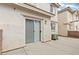 A patio area is right outside the sliding glass door of this beige home at 3023 Sunset Harbor Ct, North Las Vegas, NV 89031