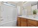 Bright bathroom features a shower-tub combo, single sink vanity and neutral walls at 3023 Sunset Harbor Ct, North Las Vegas, NV 89031