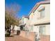 A row of two-story homes with neutral paint and a well-kept exterior, under a clear blue sky at 3023 Sunset Harbor Ct, North Las Vegas, NV 89031