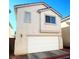 A two-story home with a garage, neutral paint, and a well-kept exterior at 3023 Sunset Harbor Ct, North Las Vegas, NV 89031