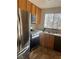 Kitchen featuring wood cabinets, stainless steel appliances, and a large window at 3023 Sunset Harbor Ct, North Las Vegas, NV 89031