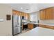 A kitchen with stainless steel appliances, wooden cabinets, and white countertops at 3023 Sunset Harbor Ct, North Las Vegas, NV 89031