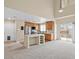 A well-lit living room with stainless steel appliances, wooden cabinets, and white countertops at 3023 Sunset Harbor Ct, North Las Vegas, NV 89031