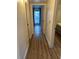 Hallway with wood floors leading to sunlit window at 3077 Pinehurst Dr # A, Las Vegas, NV 89109