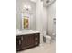 Modern bathroom with dark brown vanity, white sink and toilet, and mosaic tile at 4024 Desert Trace Ct, Las Vegas, NV 89129