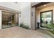 Modern courtyard entry with sleek glass doors and landscaping at 4024 Desert Trace Ct, Las Vegas, NV 89129