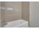 White bathtub with tan tile surround at 5751 E Hacienda Ave # 107, Las Vegas, NV 89122