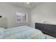 Bright bedroom with a queen bed, dresser, and window shutters at 5751 E Hacienda Ave # 107, Las Vegas, NV 89122