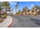 Community entrance with palm trees and landscaping at 5751 E Hacienda Ave # 107, Las Vegas, NV 89122