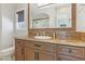 Bathroom featuring a granite countertop, custom cabinetry, framed mirror and a glass-enclosed shower at 1529 Villa Rica Dr, Henderson, NV 89052