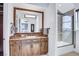 Bathroom vanity area with granite countertops, wood cabinets, and shower with glass door at 1529 Villa Rica Dr, Henderson, NV 89052