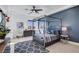 Bright bedroom features a 4 poster bed frame, natural light and blue and gray accents at 1529 Villa Rica Dr, Henderson, NV 89052